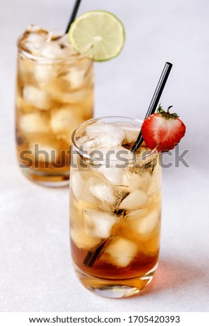 Gasses of Cold Citrus and Strawberry Ice Tea Decorated with Slice of Lemon and Strawberry Healthy Summer Drink Vertical