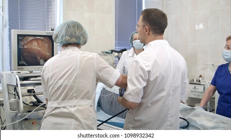 Gastroenterologist doctors with probe performing gastroscopy