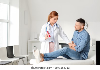 Gastroenterologist Examining Man In Clinic