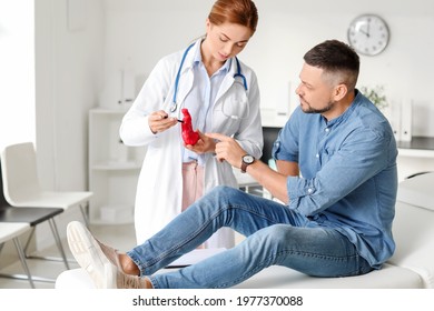 Gastroenterologist Examining Man In Clinic