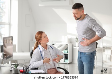 Gastroenterologist Examining Man In Clinic