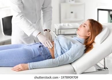 Gastroenterologist examining woman in clinic