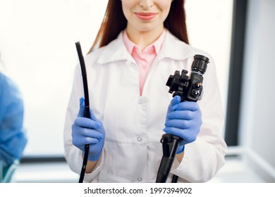 Gastrointestinal fiberoptic endoscopy concept. Cropped close up shot of female doctor holding modern endoscope device before gastroscopy examination