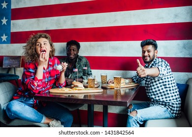 Gastropub..Young,happy Friends Having A Resting In Bar  Together, Women And Man At Cafe, Talking, Laughing Eat Fast Food.