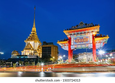 The gate to chinatown in Yaowarat at night, Bangkok, Thailand. The words on the gate say "Sheng Shou Wu Jiang" which means "Long Live the King" - Powered by Shutterstock