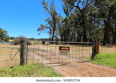 A Gate In A Fence On A Farm In The Australian Outback With A Sign Warning To Keep Out.