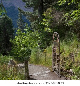Gate at a footpath through forest, Queenstown Hill Time Walkway, Queenstown, Otago Region, South Island, New Zealand