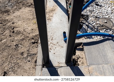 Gate foundation and ground cables creating an entrance to a new property
