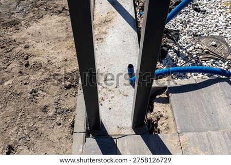 Gate foundation and ground cables creating an entrance to a new property