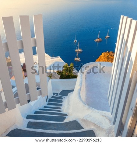 Gate to heaven. Santorini, Greece. White architecture, open doors and steps to the blue sea of Santorini. Holidays in Greece, Santorini.