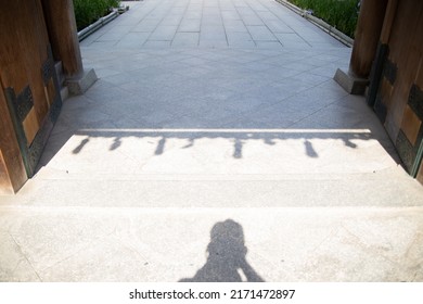 Gate Of A Japanese Temple With A Shadow Of Paper Amulets. 