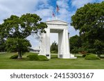 The gate monument in Peace Arch Park, Blaine, Washington, USA. Two countries flags on the monument in Peace Arch Park. USA Canada border. Historical landmark in Surrey, BC-August 30, 2023