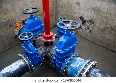 Gate Valves In Valve Pit Of The Underground Piping Networks. Laying Water System Pipeline At Construction Site. Water Supply Pipeline, Pipes In Trench. Sewage Pumping Stations, Stormwater, Utilities