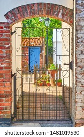 Gated entrance to a cottage courtyard off the high street in Blakeney