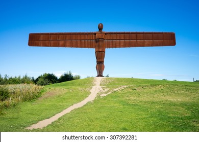 GATESHEAD, UK - AUGUST 13, 2015. The Angel of the North, Gateshead.  A steel sculpture by Antony Gormley, stands 66 feet high with a wing span of 177 feet.  The sky is blue, the Angel isolated.