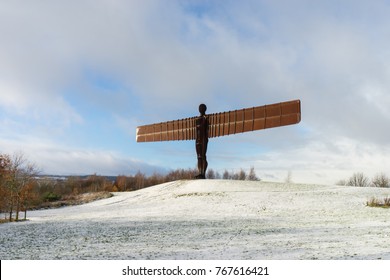 GATESHEAD, UK - NOVEMBER 30, 2017. The Angel of the North, Gateshead. A steel sculpture by Antony Gormley, stands 66 feet high with a wing span of 177 feet. The ground is covered in snow.