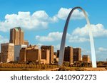 Gateway Arch against a cloudy blue sky in St. Louis Missouri along the Mississippi River.