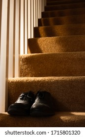 Gathering Dust: Once Polished And Used To Go To The Office Every Day, A Pair Of Black Men's Dress Shoes Are Left Unused On The Stairs During The Novel Coronavirus Pandemic