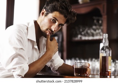 Gathering Thoughts After A Hectic Day. Young Sophisticated Man Drinking Whiskey Alone At The Bar.