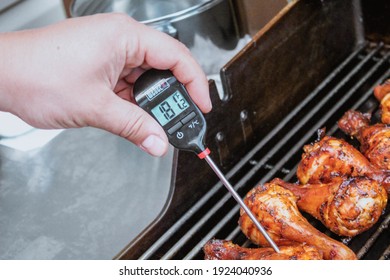 Gatineau, Quebec Canada - July 18, 2020: A Food Thermometer Checking That Chicken Is Being Cooked Correctly, Safely On A Barbecue Along With Prawns On A Sunny Day In The Garden. Weber Thermometer