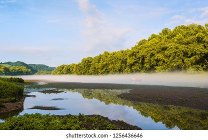 Gatlinburg, USA - August 25, 2014: Couple In Their Small Boat To Row Down The Little Tennessee River As Dawn Mist Lifts At Dawn On August 25, 2014 Near Gatlinburg, Tennessee, USA.