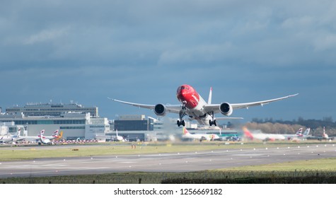 GATWICK AIRPORT, ENGLAND, UK – DECEMBER 09 2018: A Norwegian Airlines Plane Takes Off From London Gatwick Airport, With Jet Wash Wake Turbulence Coming Out From The Rear Of Its Engines.