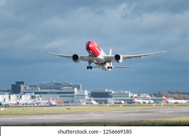 GATWICK AIRPORT, ENGLAND, UK – DECEMBER 09 2018: A Norwegian Airlines Plane Takes Off From London Gatwick Airport, With Jet Wash Wake Turbulence Coming Out From The Rear Of Its Engines.