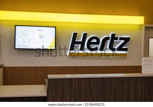 Gatwick Airport, UK- May 3, 2022: Hertz car\
rental desk at Gatwick\
Airport