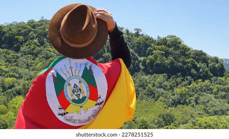 Gaucho with hat and flag of the state of Rio Grande do Sul - Southern Brazil. Nature background. - Shutterstock ID 2278251525
