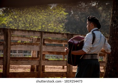 Gaucho Playing Harmonica On His Back.