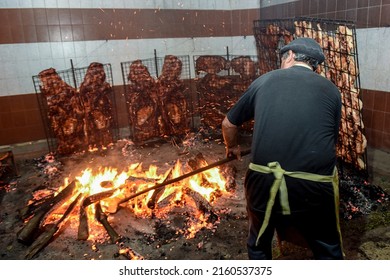 Gaucho roast barbecue, sausage and cow ribs, traditional argentine cuisine, Patagonia, Argentina. - Shutterstock ID 2160537375