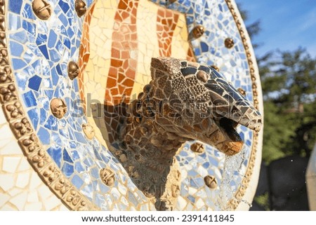 Gaudi Snake and four Catalan bars in modernism mosaic ceramic tile, decoration in Park Guell, Barcelona, Spain.