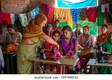 Gautam Budh Nagar, Uttar Pradesh, India-Sep 12 2016: Woman Teaching Stitching And Tailoring Class, Under Vocational Training Course. Empowering Women Through Stitching  Tailoring Classes