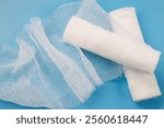 Gauze medical bandage on a blue background. Bandages for dressing.