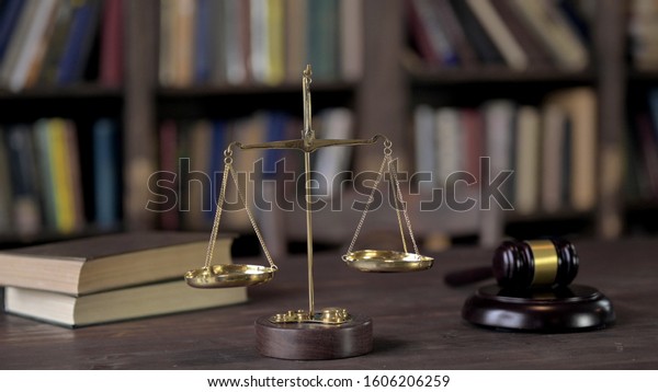 Gavel and Balance\
Scale on Judge Wooden\
Table