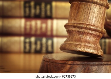 Gavel, With Defocussed Law Books Behind.