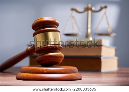 gavel hammer with libra scale and stack of books             