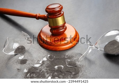 gavel of justice on the background of a broken hourglass. end of action time. expiration concept