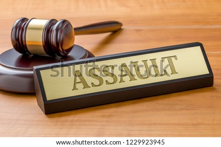 A gavel and a name plate with the engraving Assault