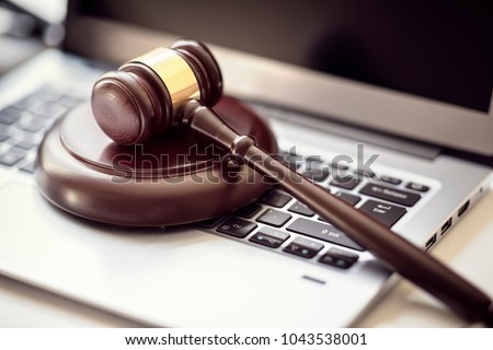 Gavel on laptop computer keyboard concept for online internet auction or legal attorney assistance