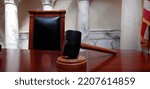 Gavel on wooden desk or table in Court or legislature lawmaker office hall