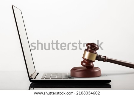 Gavel placed on laptop pc. Company known for its surveillance software.