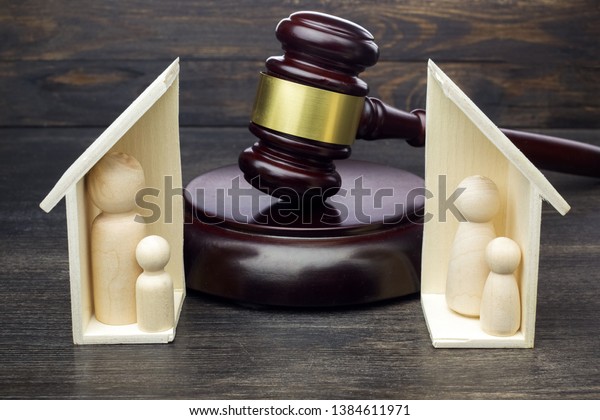 Gavel showing separation of family and house\
on dark wooden background