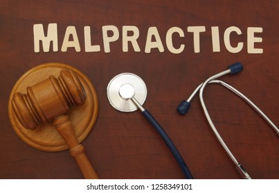 Gavel And Stethoscope On Wooden Background, Malpractice Concept