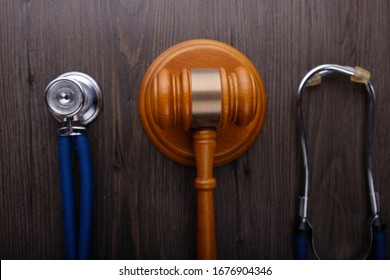 Gavel And Stethoscope On Wooden Background, Symbol Photo For Bungling And Medical Error. Medicine Laws And Legal, Medical Jurisprudence.