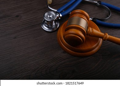 Gavel and stethoscope on wooden background, symbol photo for bungling and medical error. Medicine laws and legal, medical jurisprudence.