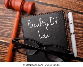 Gavel,pen,glasses And Notebook Written With Text Faculty Of Law On A Wooden Background.