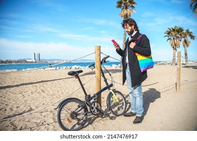 Gay Browsing Smartphone Near Bicycle On Shore