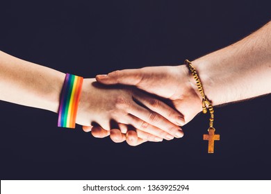 Gay And Christian Person Shaking Hands. LGBT And Catholic Community. Tolerance And Peacemaking Gesture.