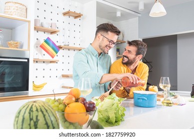 Gay Couple Cooking Food In Kitchen